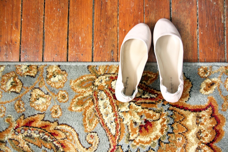 Shoes on blue rug.
